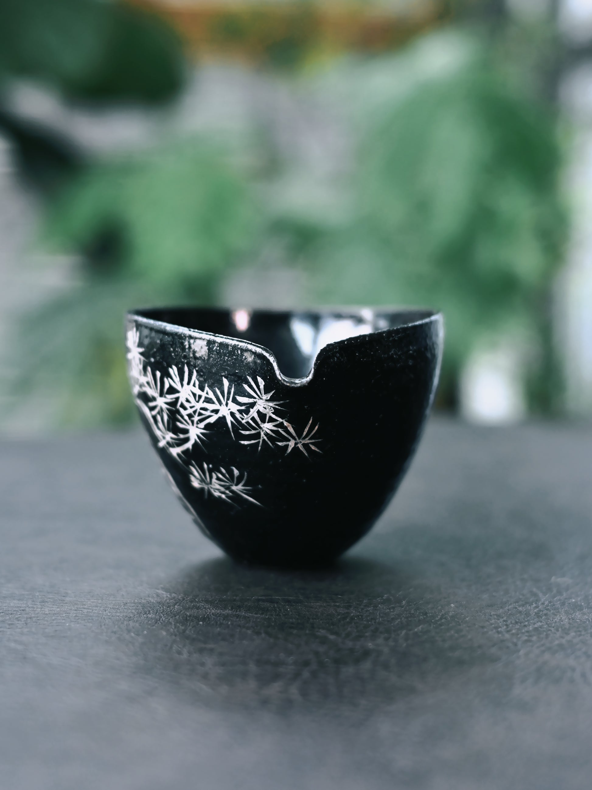 Wabi-sabi tea set in glossy black glaze with hand-painted silver poetry and pine motifs, embracing imperfect beauty in Japanese tea ceremony style.