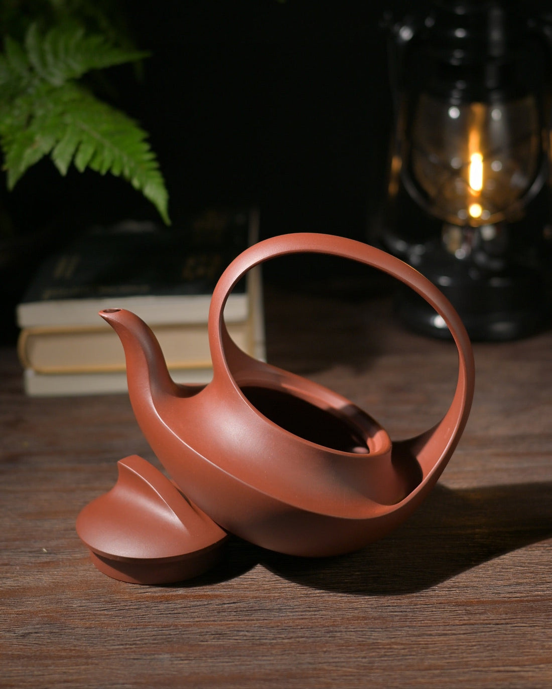 Award-winning Yixing zisha Qu Pot teapot with smooth continuous curves, handcrafted from purple clay.