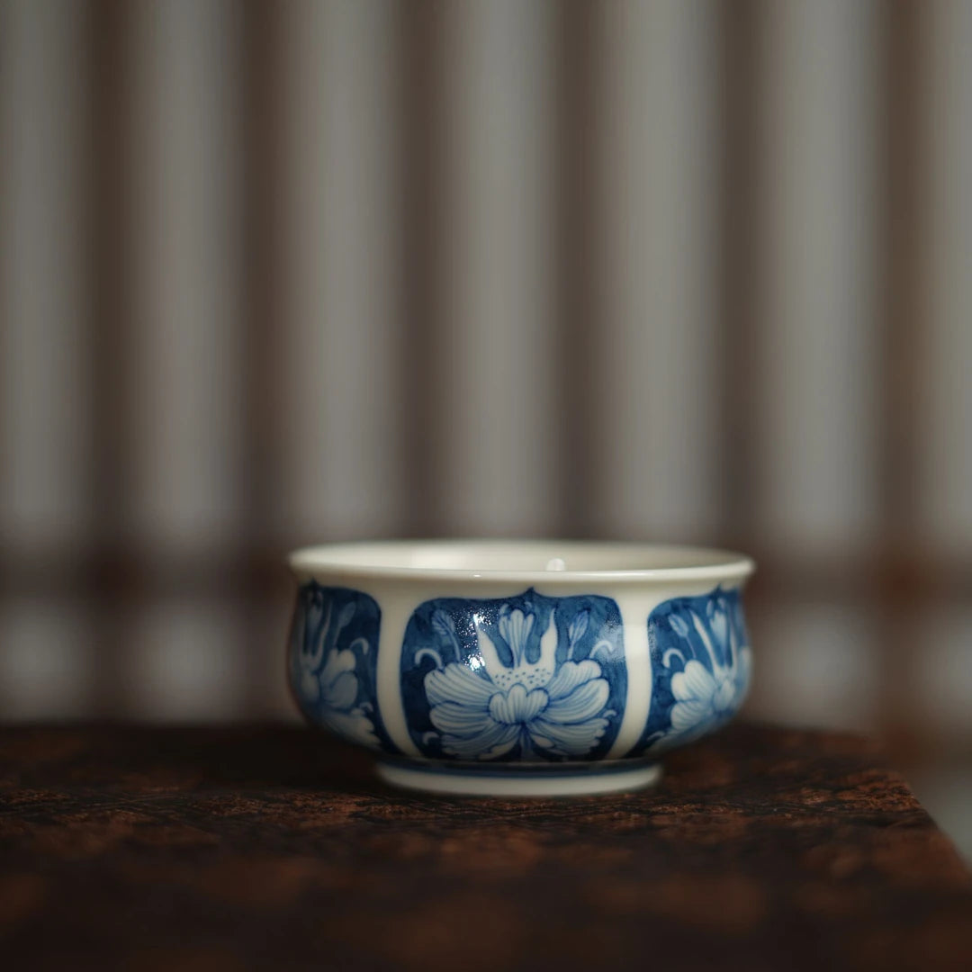Side view of a 100ml Chinese teacup featuring traditional cobalt blue peony motifs.
