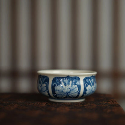 Side view of a 100ml Chinese teacup featuring traditional cobalt blue peony motifs.