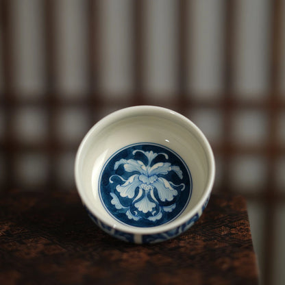 Interior view of a blue-and-white teacup showing a central peony flower medallion.