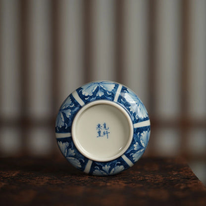 Traditional Qinghua porcelain teacup with a hidden floral surprise at the bottom.