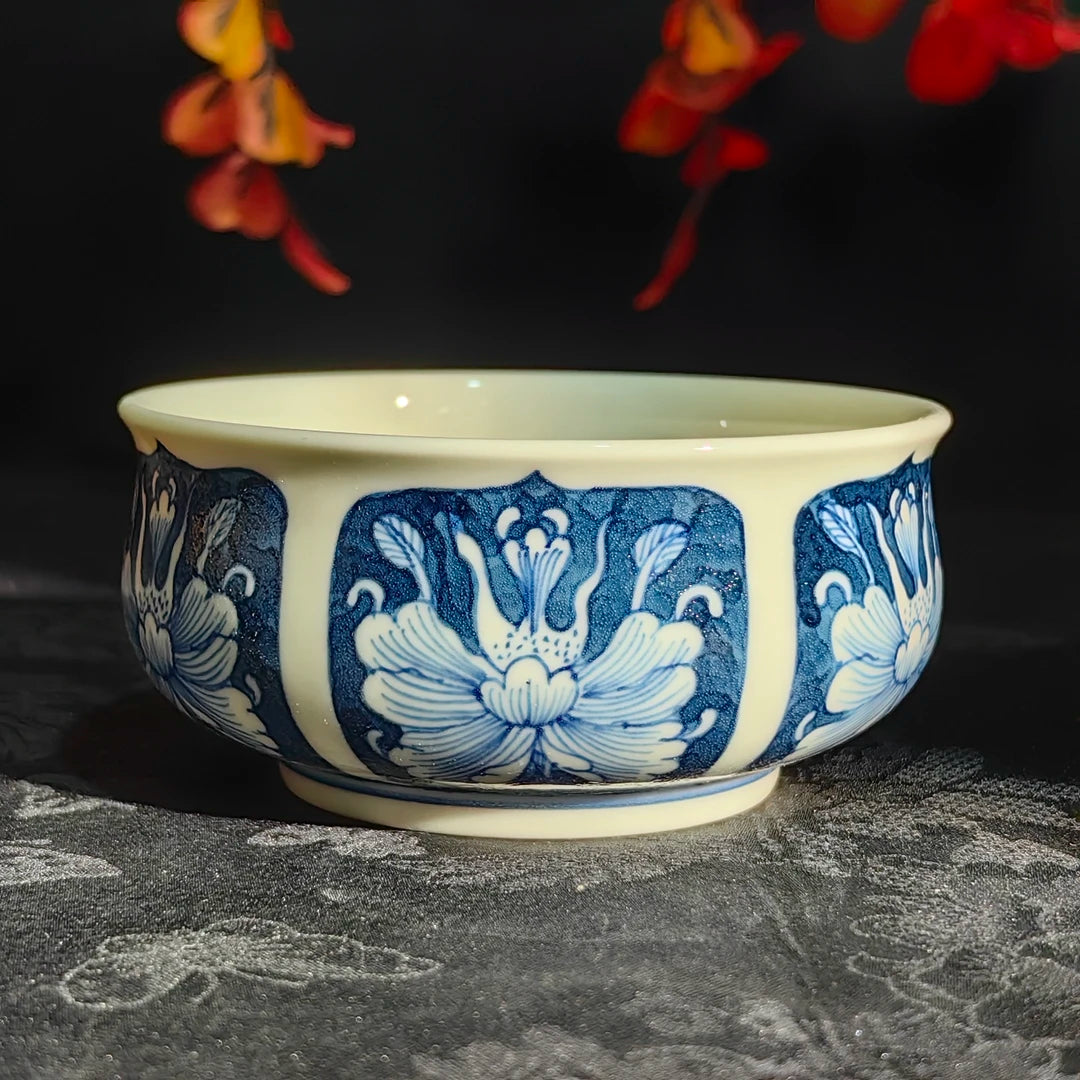 Base of the antique peony teacup showing the artisan's handwritten blue signature mark.