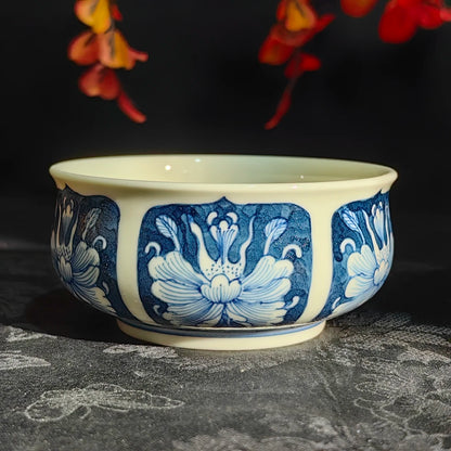 Base of the antique peony teacup showing the artisan's handwritten blue signature mark.