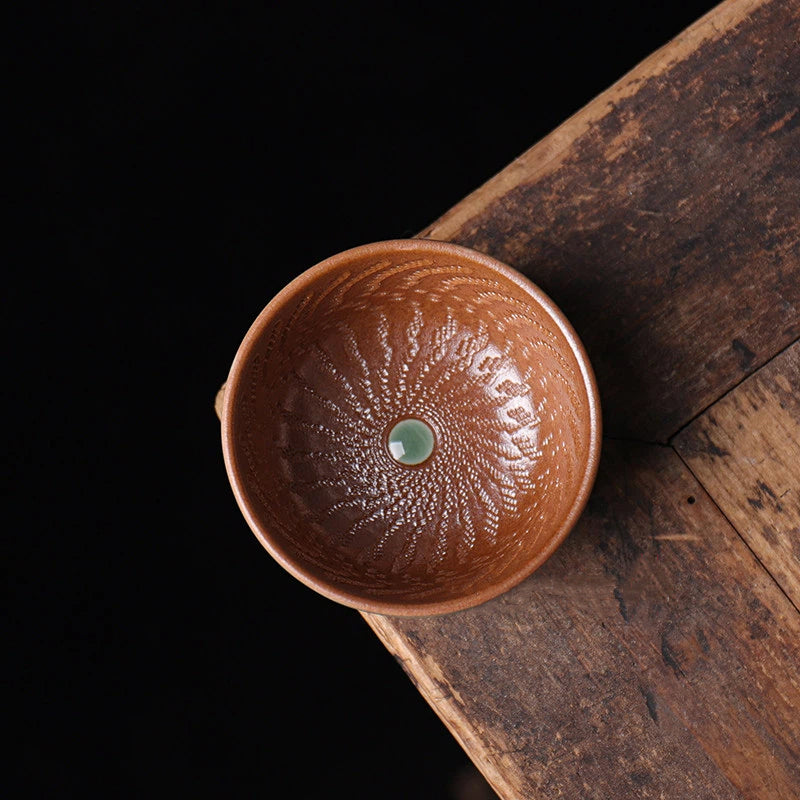 Artisanal wood ash fired teacup with a unique contrast between a ribbed interior and a smooth sculptural exterior.