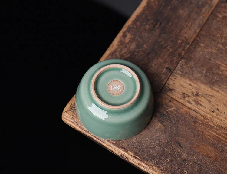 Premium Longquan Celadon tasting cup for Pu-erh tea, featuring professional Tiao Dao craftsmanship and Plum Green glaze.