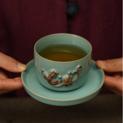 Gongfu tea setup featuring Ru Ware sky-blue 150ml Chi dragon master cup on dark tea table