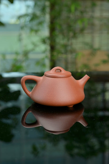 Traditional Shipiao style Yixing teapot crafted from zhuni clay using semi-handmade methods, honoring Chinese tea culture.