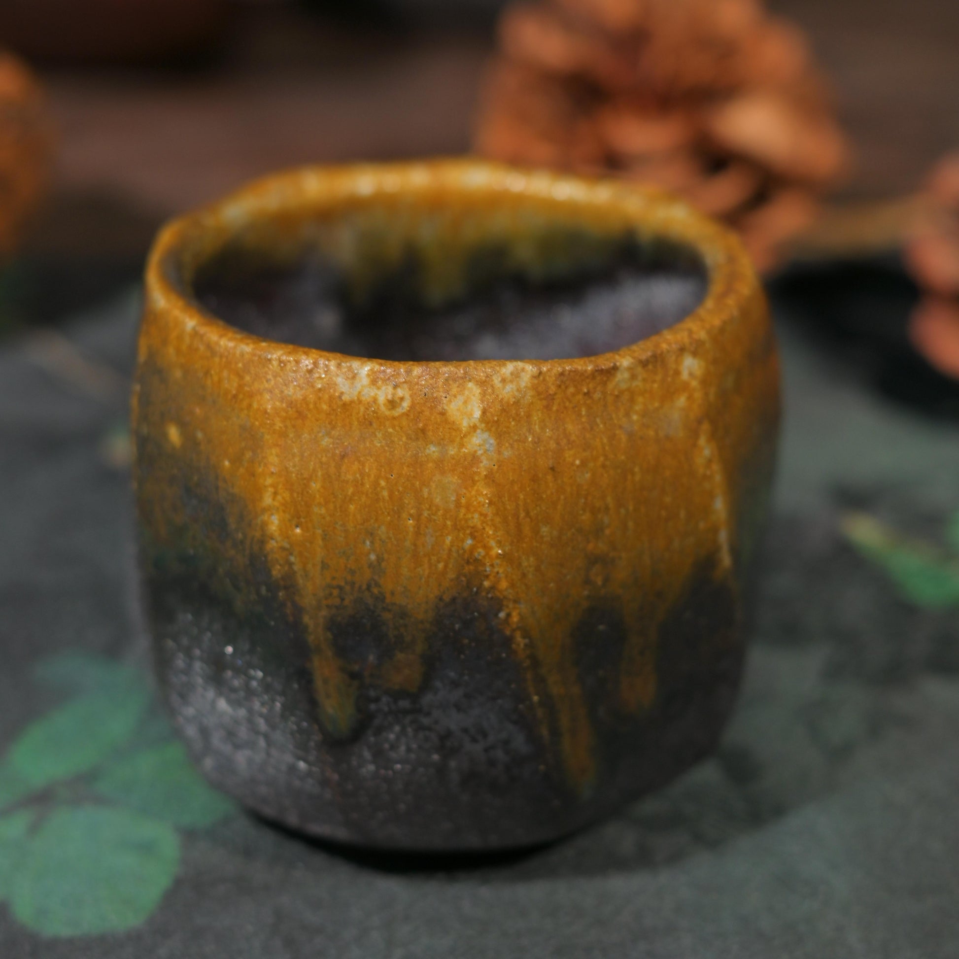 Detailed view of the hand-cut facets and scorched finish of a wood-fired artisan vessel.