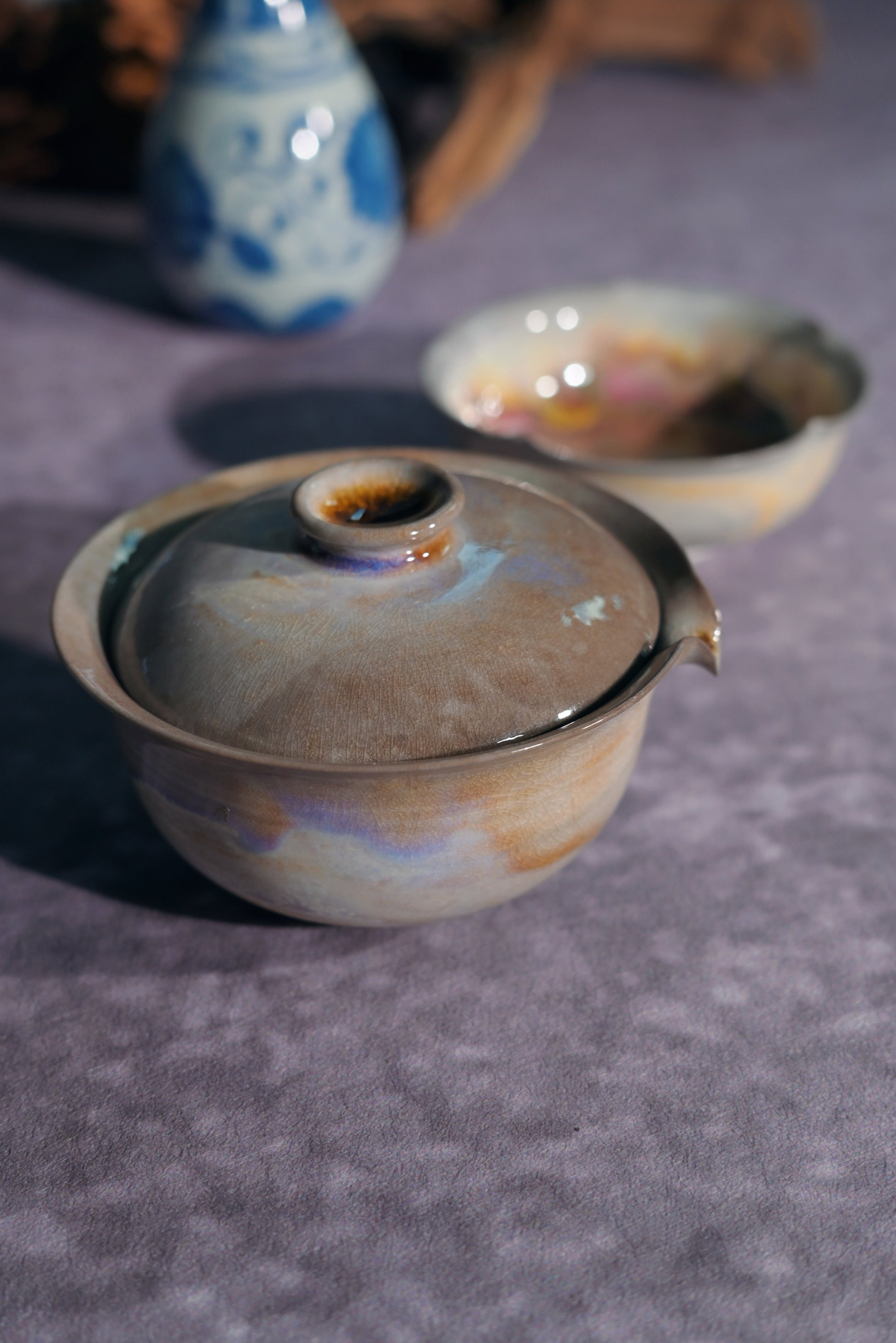 Detailed view of the natural ash deposit and metallic luster on a professional-grade tea vessel.