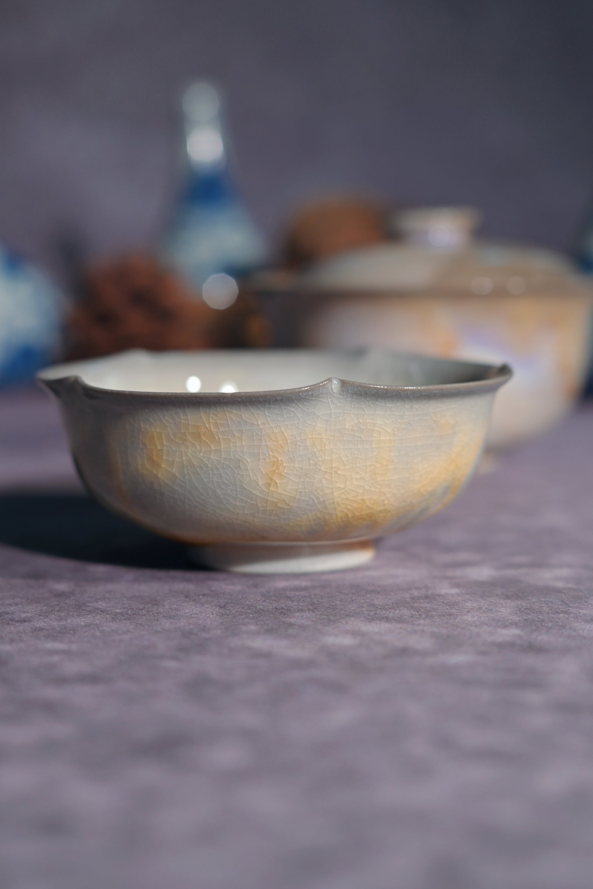 A breathtaking singular edition wood-fired Gaiwan set displaying a rare pearlescent "Aurora" kiln-change effect.