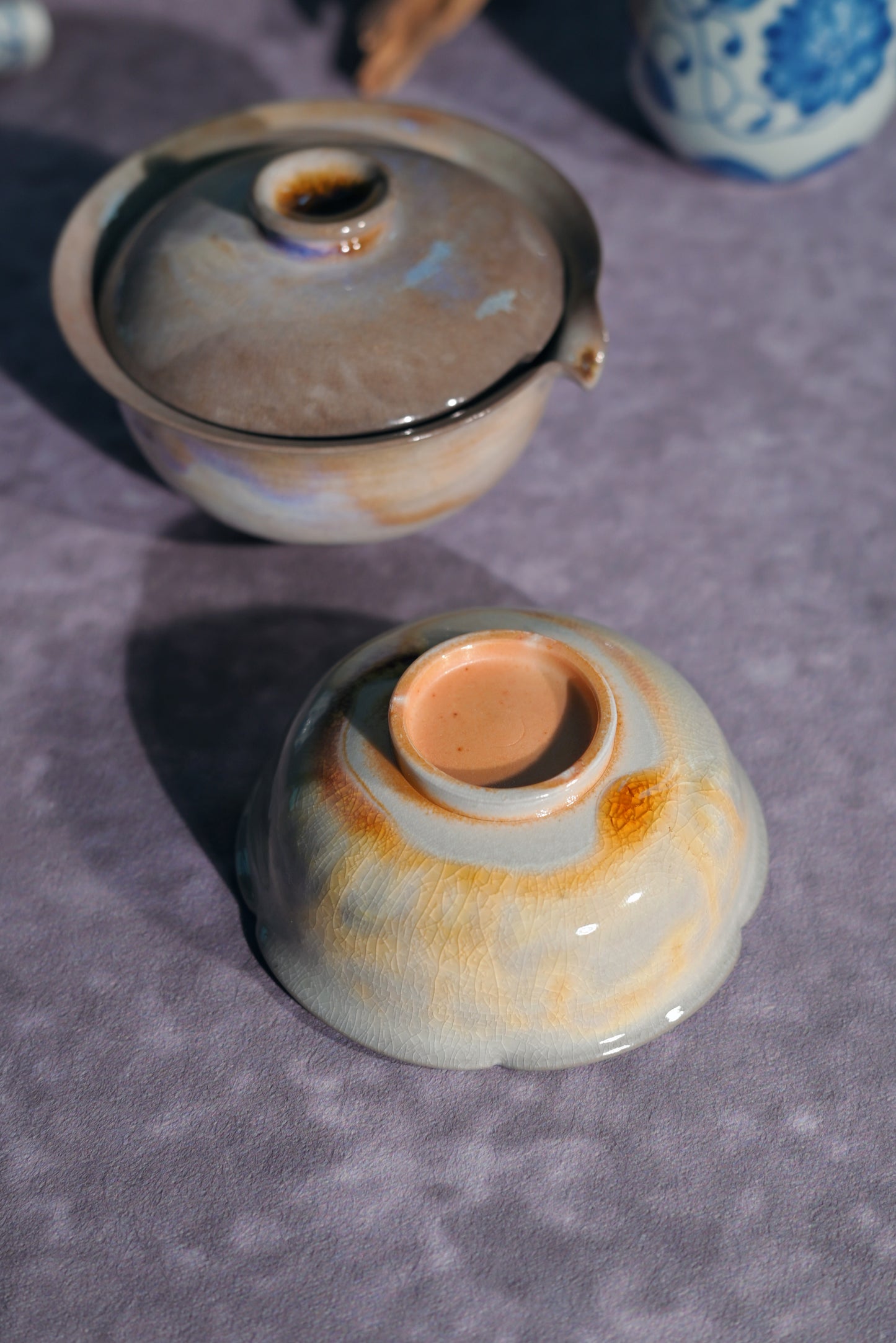 Artisan wood-fired tea duo featuring a high-fired stoneware Gaiwan and matching floral-inspired tea bowl.