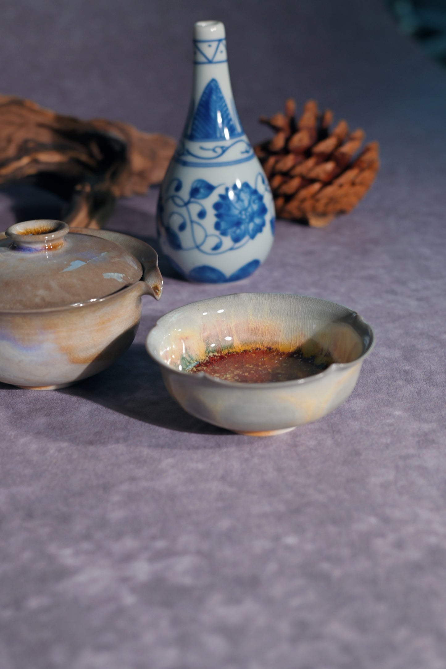 Macro view of the delicate Kannyu crackle texture beneath the iridescent aurora surface of a handmade Gaiwan.