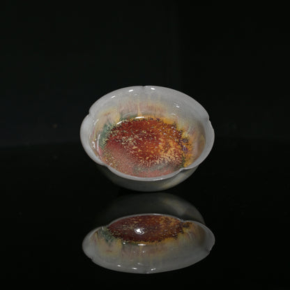Hand-formed flower-petal tasting cup showcasing delicate wood-fired crackle glaze.