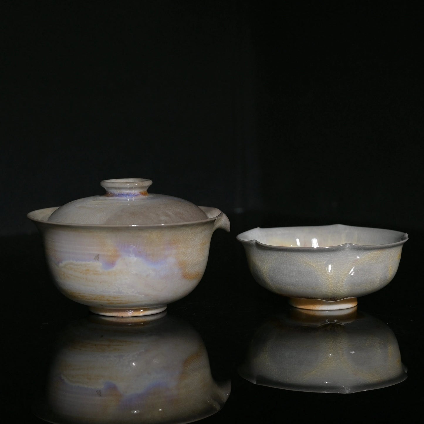 Unique wood-fired Gaiwan and flower-petal cup set with iridescent aurora glaze effects.