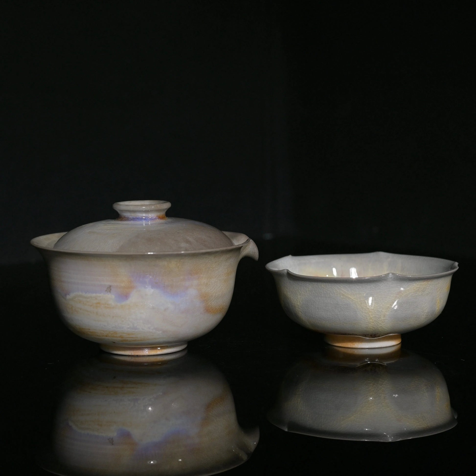 Unique wood-fired Gaiwan and flower-petal cup set with iridescent aurora glaze effects.
