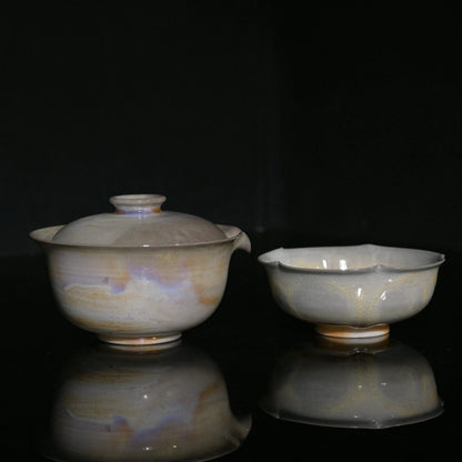 Unique wood-fired Gaiwan and flower-petal cup set with iridescent aurora glaze effects.