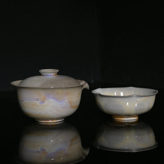 Unique wood-fired Gaiwan and flower-petal cup set with iridescent aurora glaze effects.