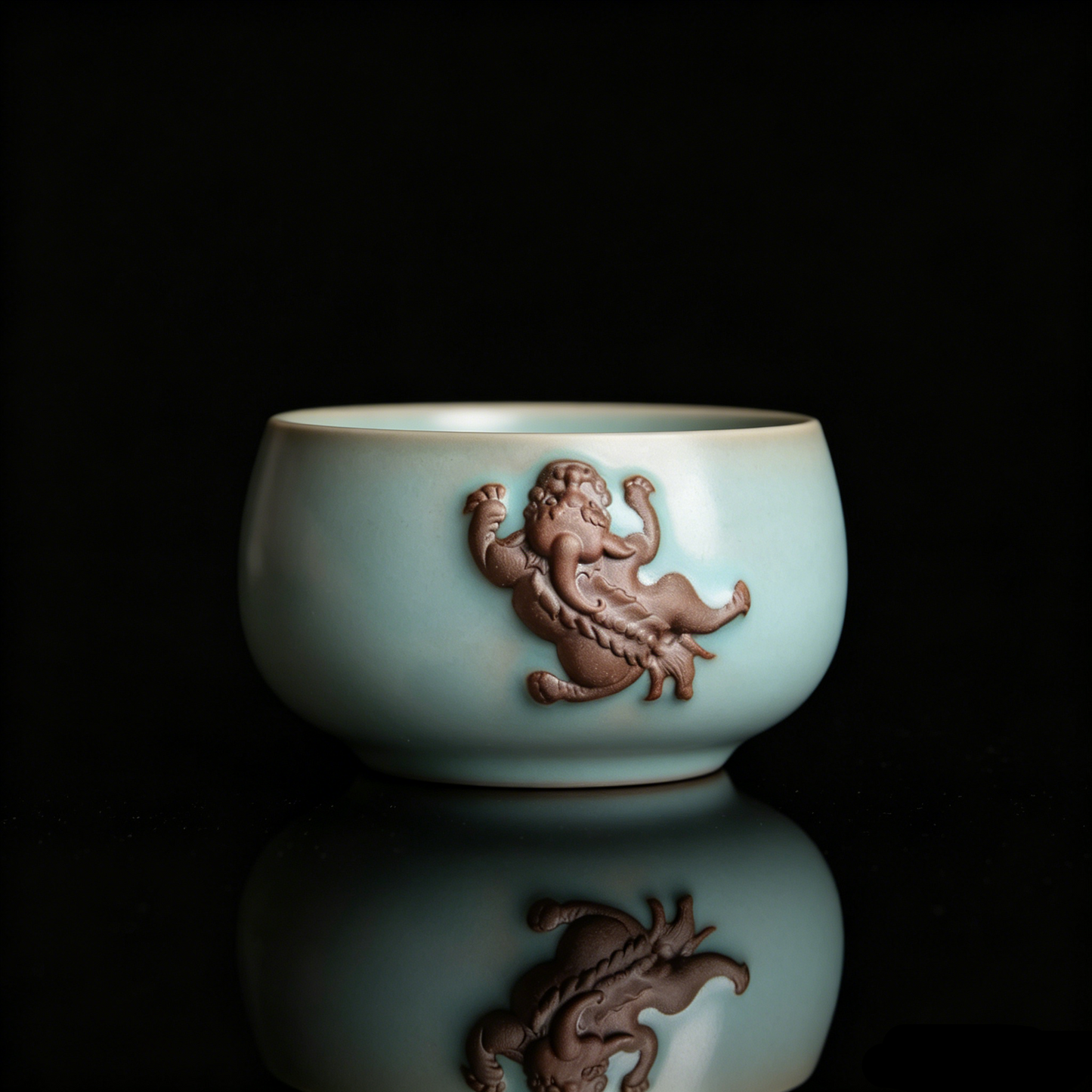 Antique finish Ru Ware teacup featuring a prominent 3D unglazed Pixiu relief on the side.