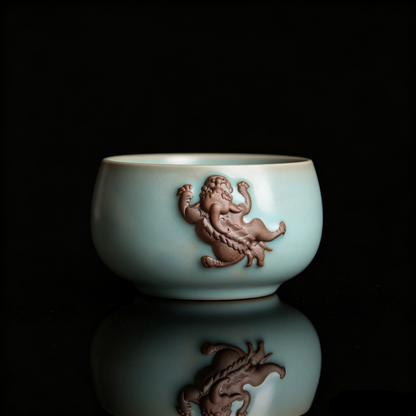 Antique finish Ru Ware teacup featuring a prominent 3D unglazed Pixiu relief on the side.