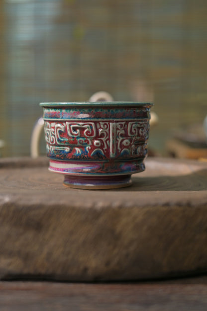 High-fired handmade teacup with dramatic flambé glaze interior effect