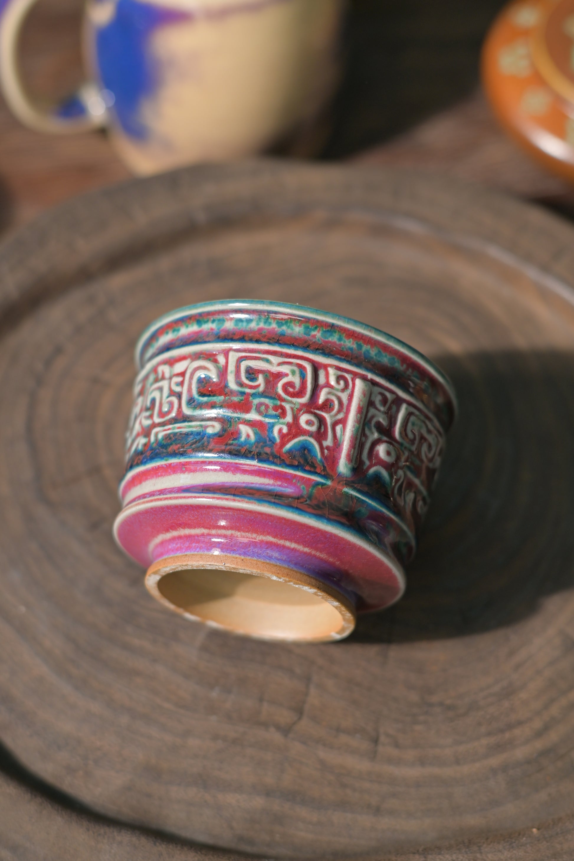 Chinese Jun ware tea cup with textured surface and antique style motif