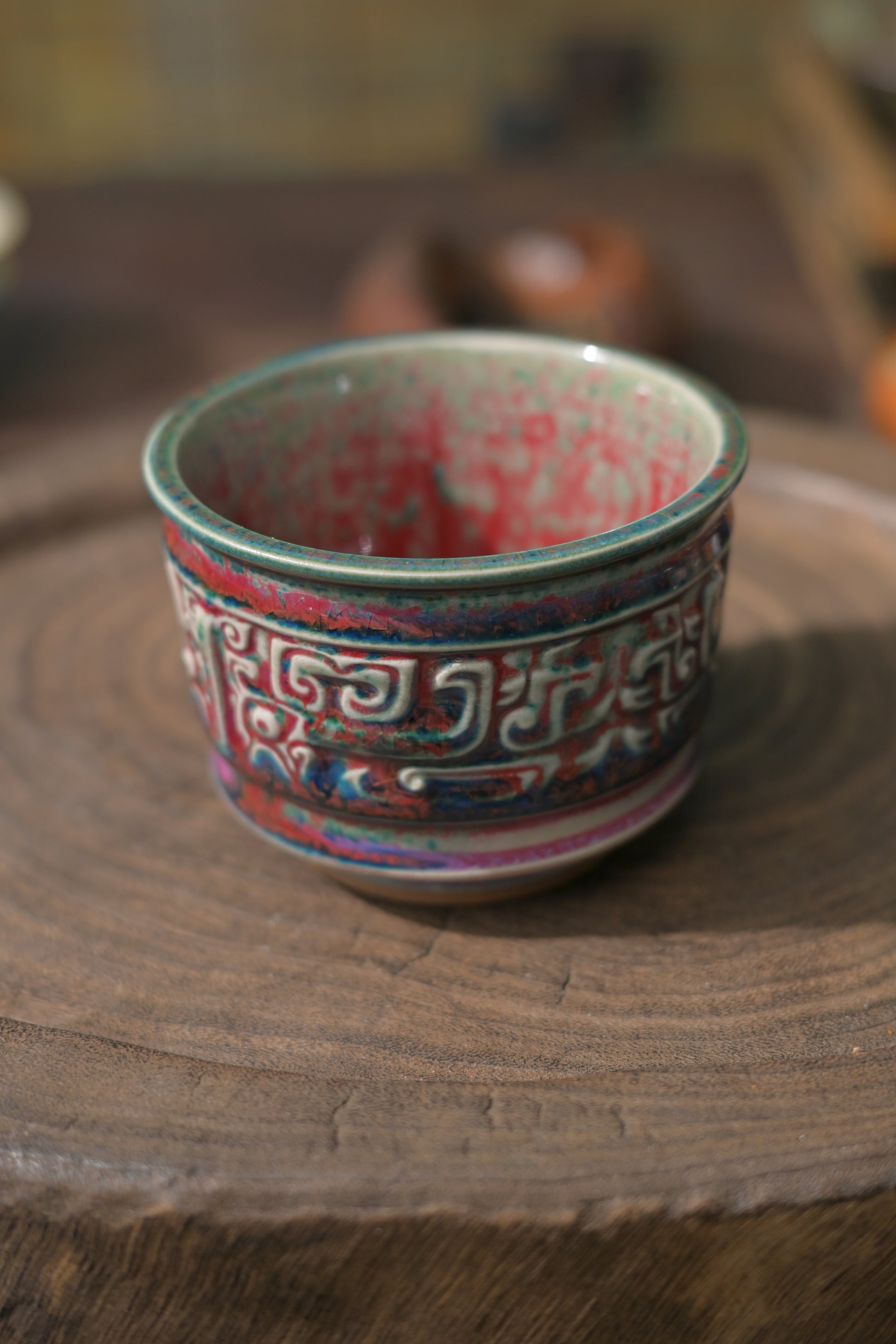 Interior view of flambé glaze teacup with vivid crimson and blue pattern