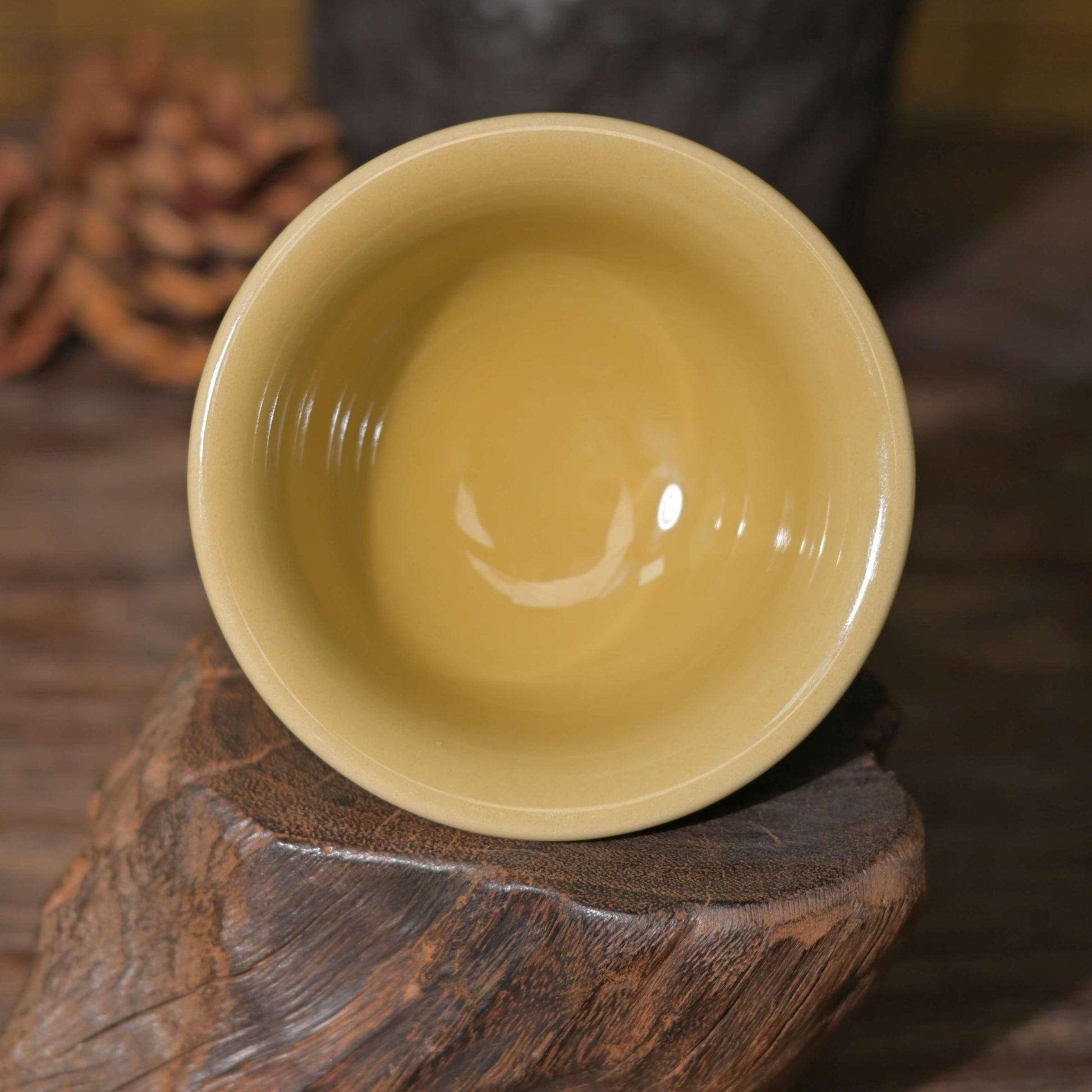 The flared rim and footed base of the unique Golden Glaze Imperial Longquan Celadon hand-carved Dragon Cup.