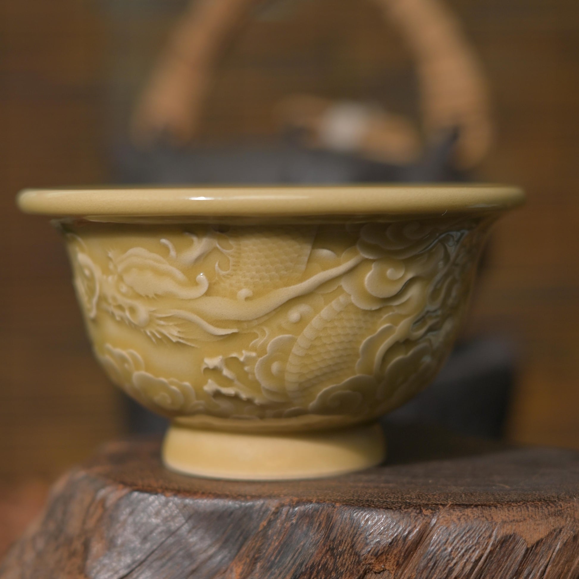 Hand-carved 3D dragon relief on an authentic Longquan Celadon stoneware tea bowl, Golden Glaze edition.