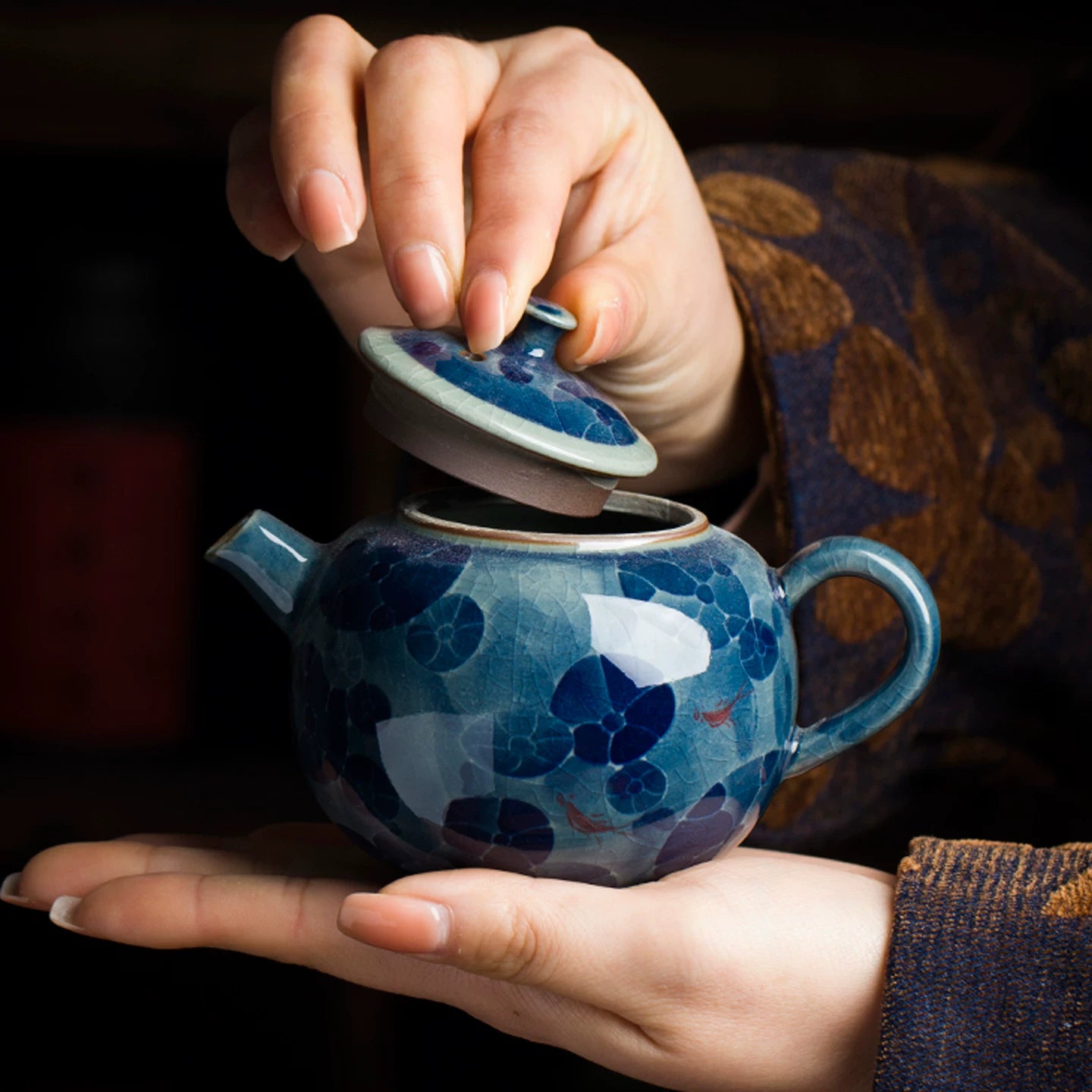 Top-down perspective of an artisan blue and white teapot showcasing the elegant lid and floral motifs.