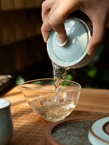 Three-piece Ru Ware gaiwan set with sky-blue glaze and intricate cicada's wing crackle pattern.