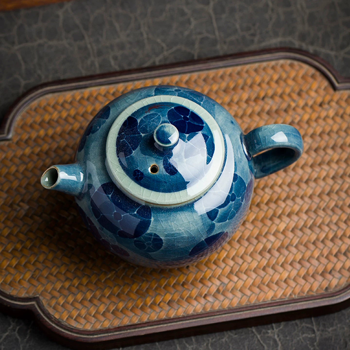 Elegant round silhouette of a blue and white teapot with a precision-pour spout and ergonomic handle.
