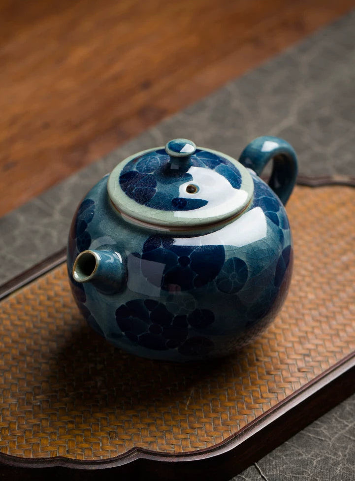 Collector's edition blue and white porcelain teapot with a serene lotus pond motif and jade-like finish.