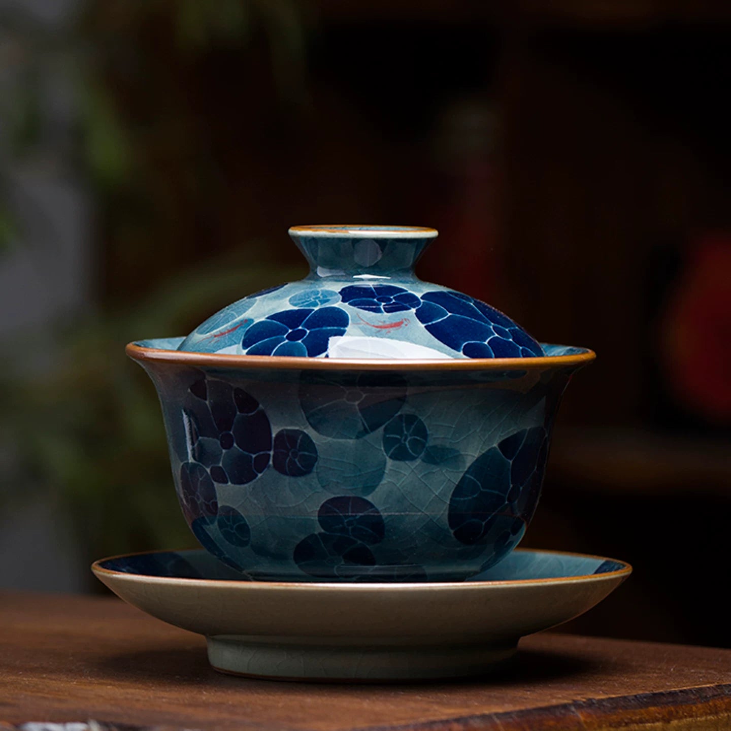 Traditional Sancai gaiwan with a serene lotus pond motif, handcrafted in Jingdezhen.