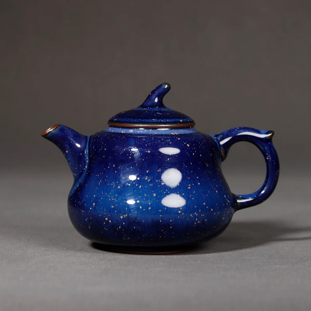 Close-up of starry night blue glaze transmutation and mineral crystals on Jun Ware teapot