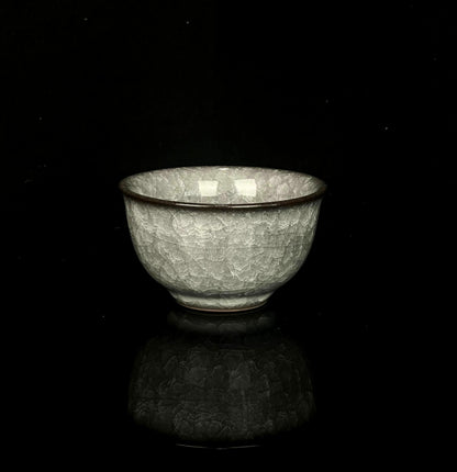 Ancient style Longquan celadon cup featuring ice crackle glaze and ya shou design for comfortable handling