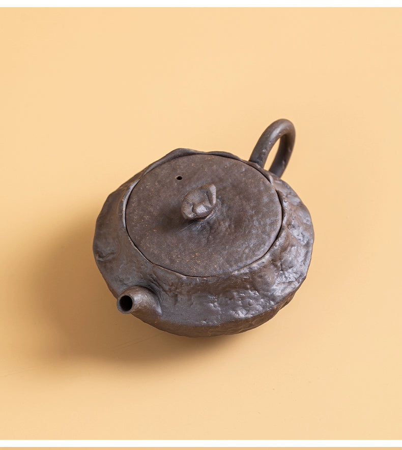 Close-up of wood-fired flat ceramic teapot texture