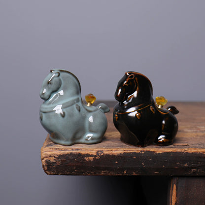 Detailed view of celadon crackle glaze and rounded horse body on ceramic tea mascot