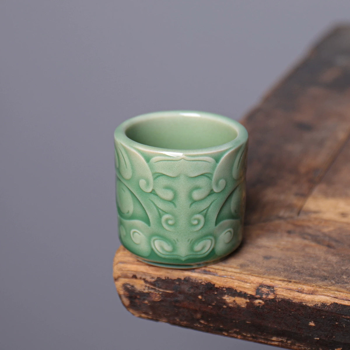 Handmade Longquan Celadon master cup displaying jade-like glaze finish and Taotie mask carving