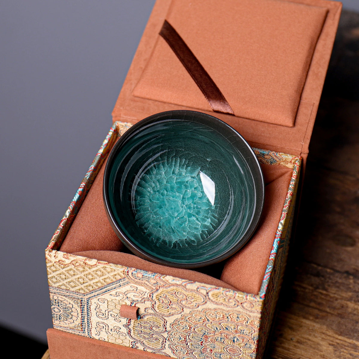 Detailed view of emerald celadon glaze and multi-layer ice crackle veins in Longquan teacup