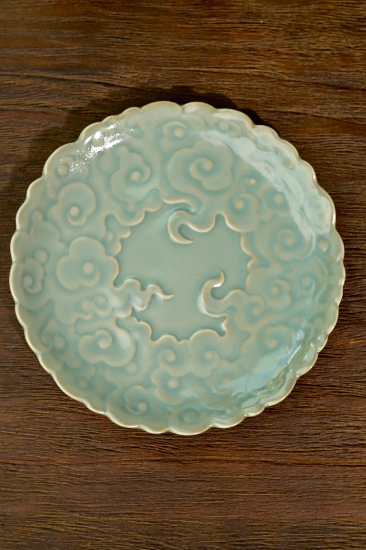Close-up of 3D carved cloud relief and celestial blue crackle glaze on Ru kiln porcelain tray