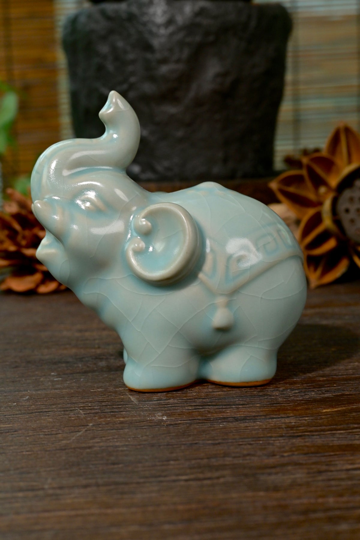 Close-up of raised trunk and celestial blue crackle glaze on handcrafted Ru Ware elephant statue