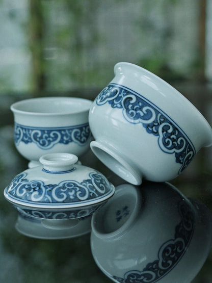 Authentic Jingdezhen gaiwan set featuring transformed imperial motifs: ruyi borders, key-fret designs, and hidden Eight Treasures symbolism in cobalt blue on white porcelain.