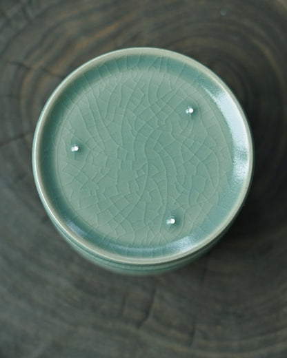 Blue-green Ru porcelain cup with jadeite-like transparency, showcasing rare Song Dynasty celadon glaze coloration