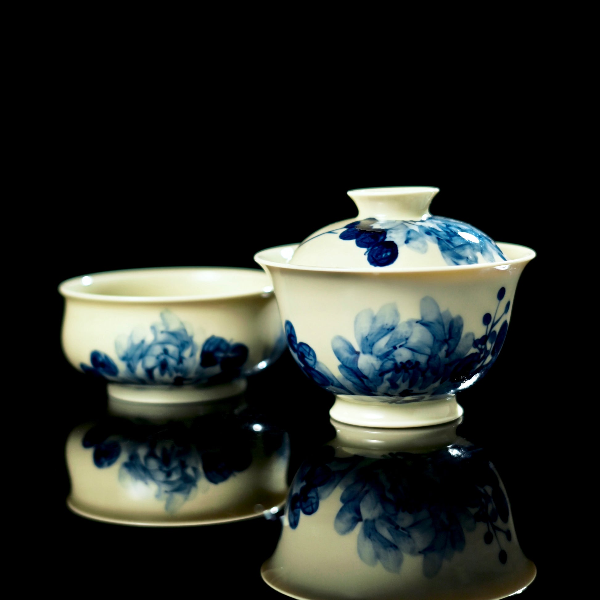 Blue-and-white gaiwan set showing hand-painted peonies on lid, bowl interior, bowl exterior, and tea cup.