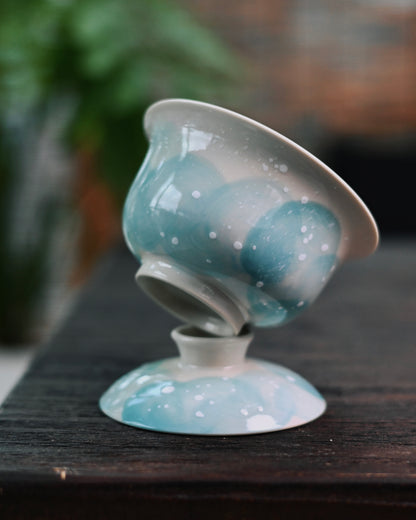 Complete winter-themed tea set featuring snowscape pattern against warm cream-colored porcelain