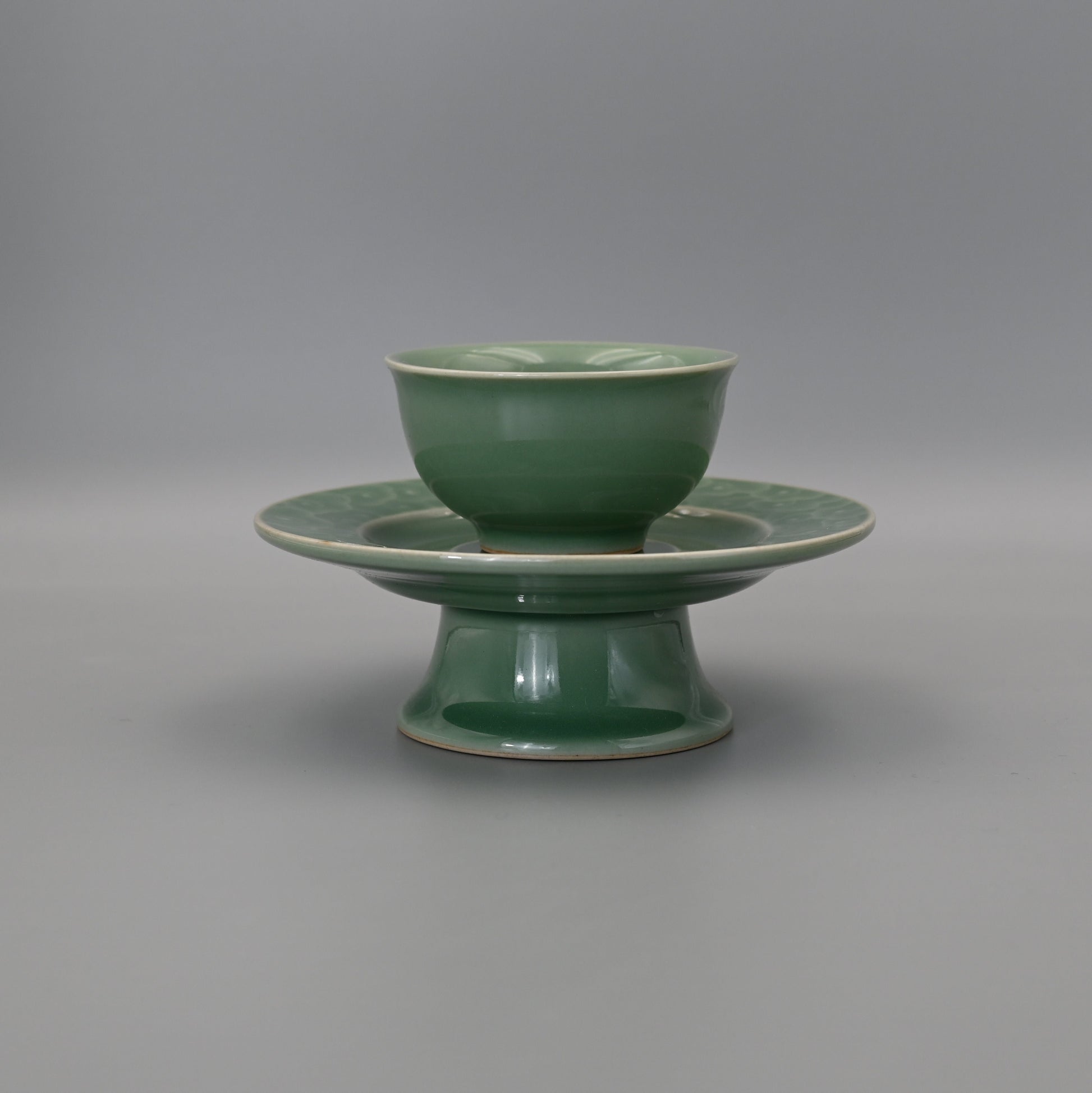 Longquan Celadon relief carved clouds pattern teacup with plum-green glaze
