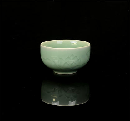 Longquan celadon plum-green glaze teacup with relife-carved lotus pattern for personal tea brewing