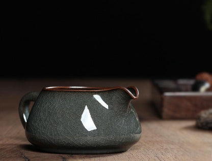 Longquan Ge kiln-style tea set including cup and fairness cup in iron-tone celadon.