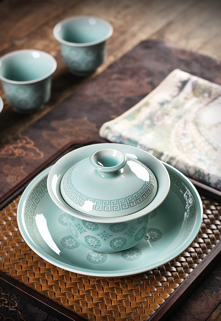 Hand-carved Chinese celadon gaiwan with rice-grain pierced floral pattern for Gongfu tea rituals